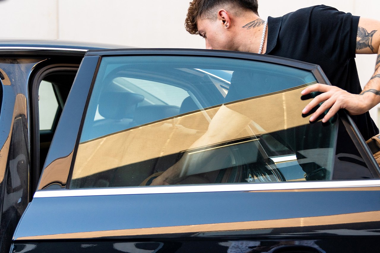Technician applying professional window tinting baton rouge to a car door