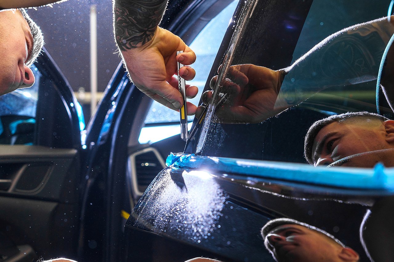 Technician preparing a vehicle for an auto glass quote and service