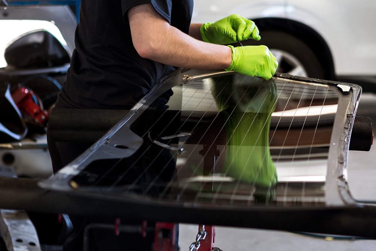 Tech performs car window repair